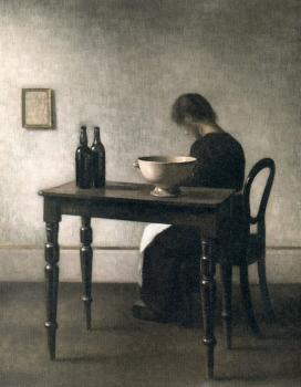 Vilhelm Hammershoi : Young woman sitting behind a table